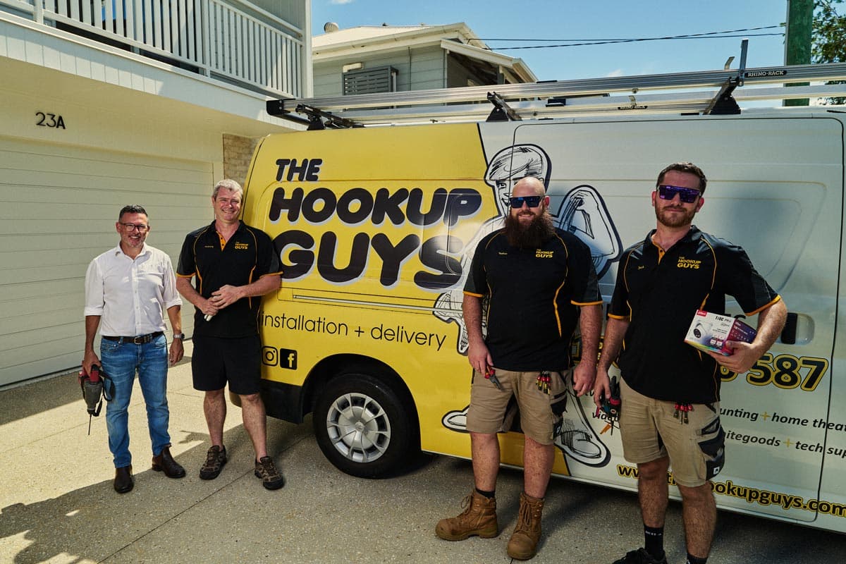 Installation team standing beside a branded service van